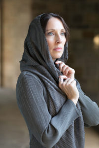 Lurainya Koerber modeling headshot photo showing blue eyes behind draping scarf